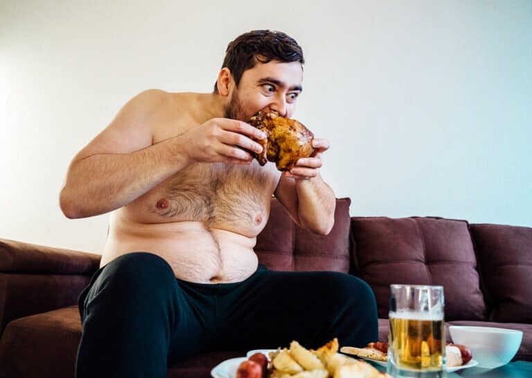 naked man eating chicken