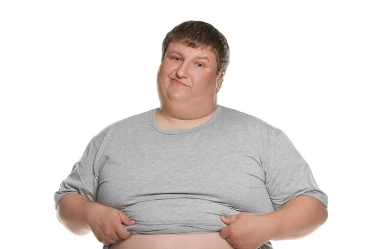 obese young man about to take off shirt