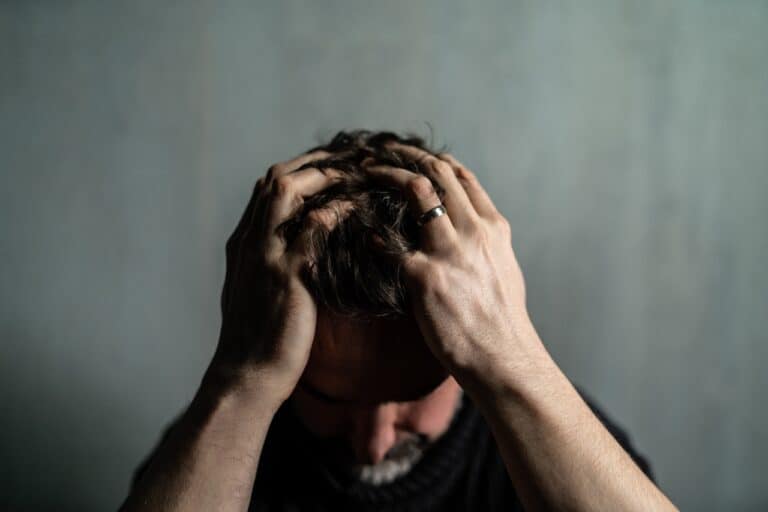 stressed man holding head